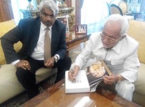 Pehin Seri Taib signing the book written about him by the author, Mr Siva Kumar G at a private autograph signing session.